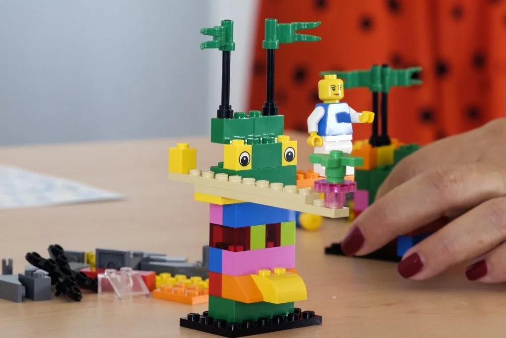 Lego construction with participant's hand.