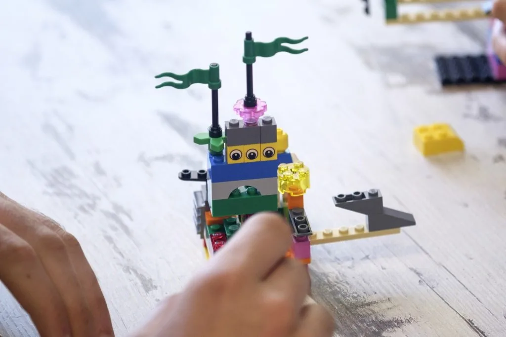 Lego construction with author's hands.