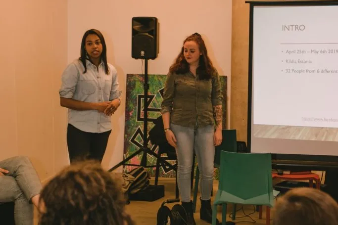 Two women presenting a slideshow.