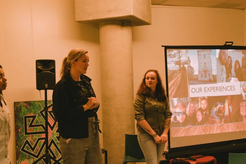 Two women presenting a slideshow.
