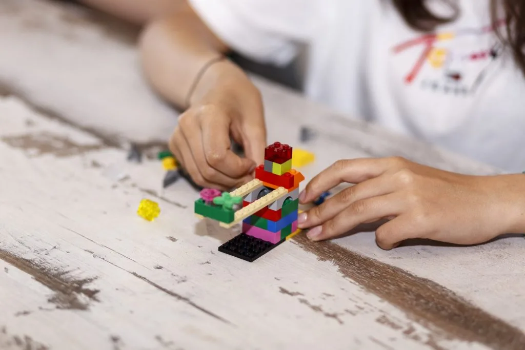 Lego construction and author's hands.