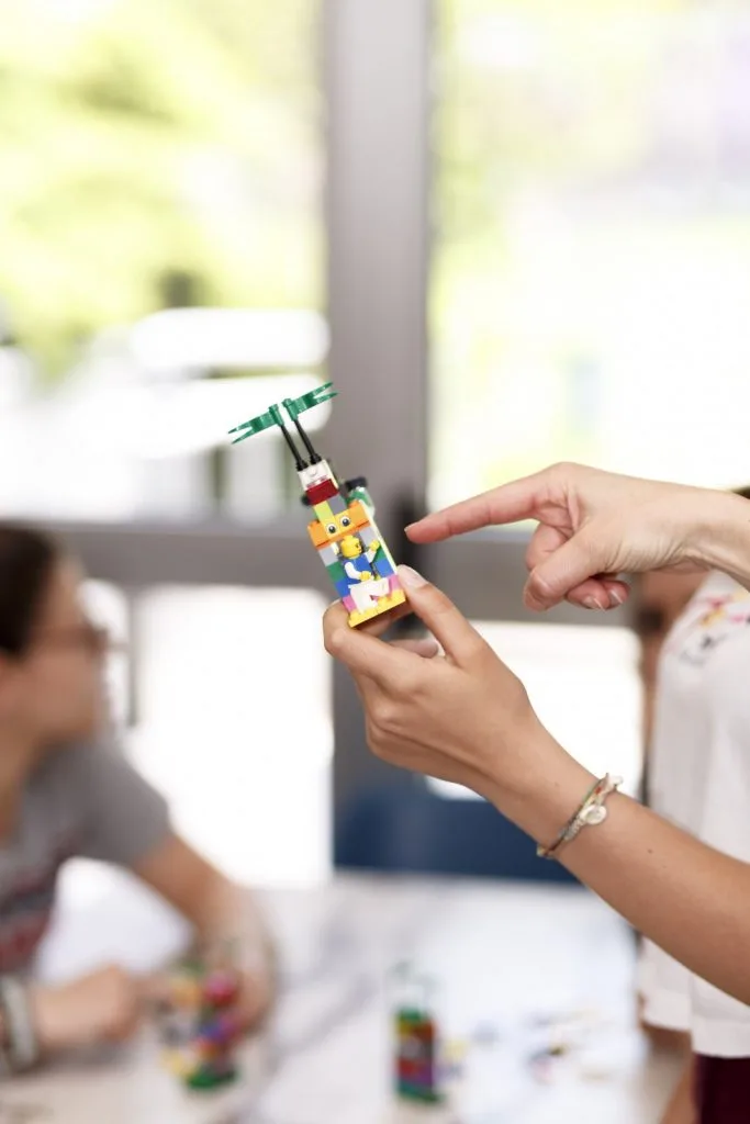 Lego construction being held and pointed at.