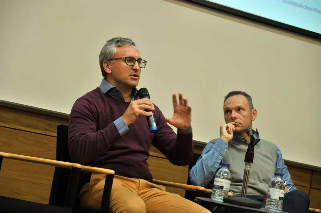 Two other roundtable participants, with one talking.