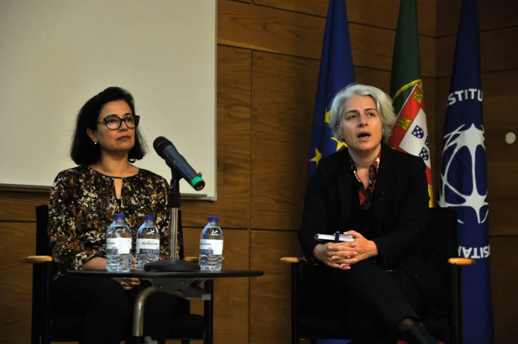 Two roundtable participants, one is Catarina Carvalho talking.