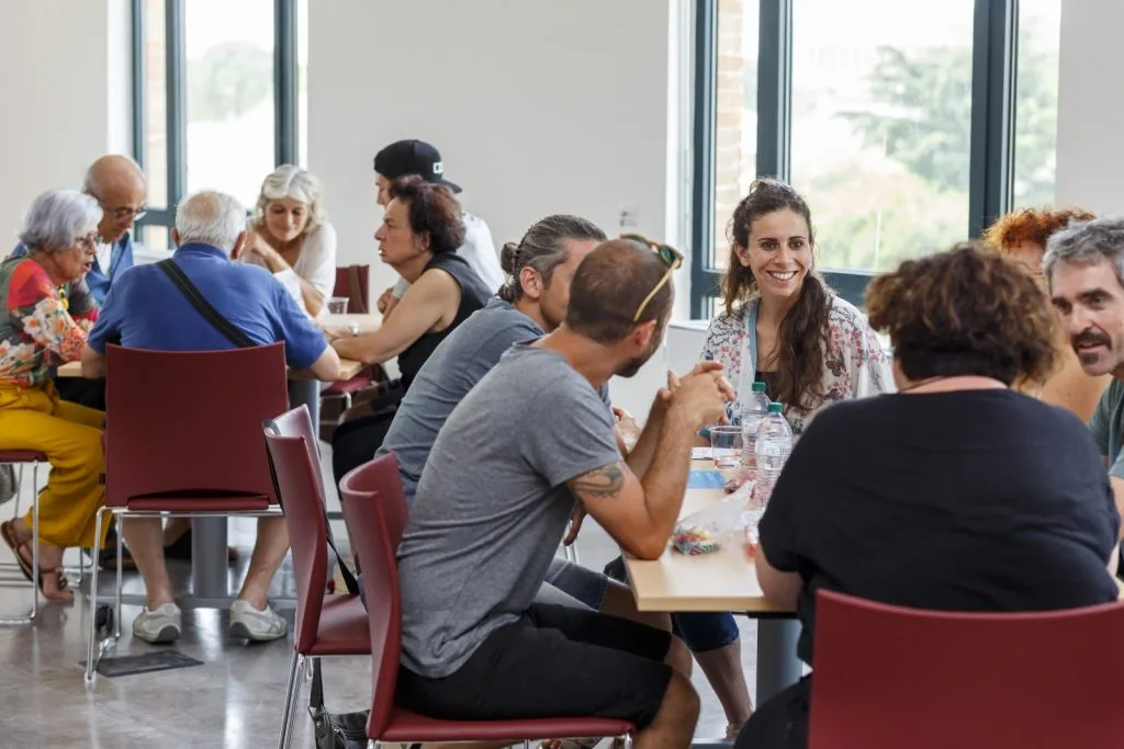 Participants seated around multiple tables.