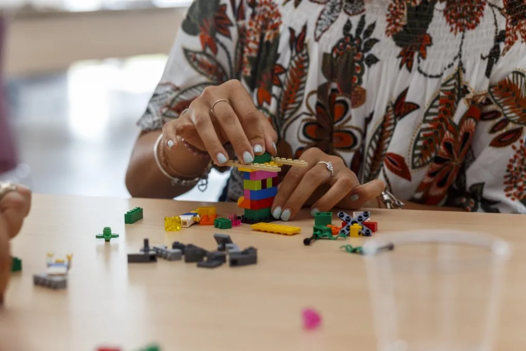 Participant's hands constructing with Lego.