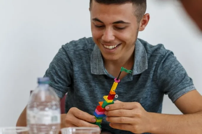 Participant holding his Lego construction.