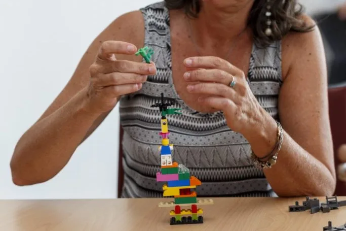 Lego construction and author's hands.