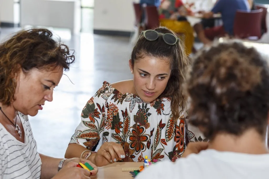 Three participants using Lego pieces.