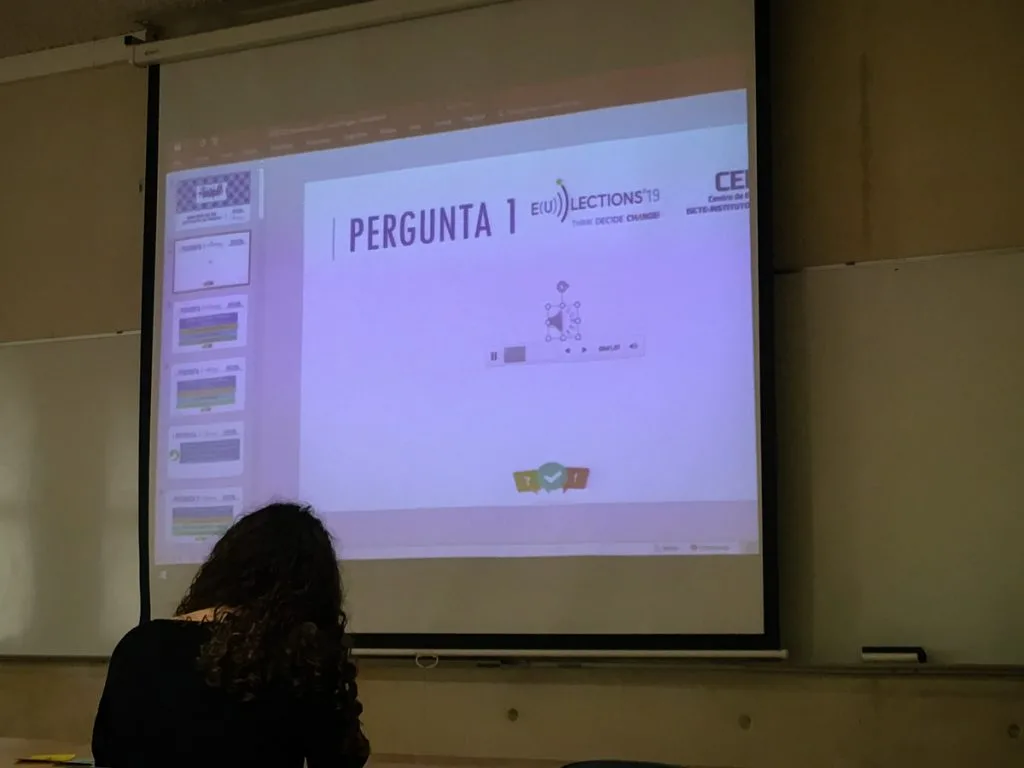 Slideshow being projected with one student seated in front.